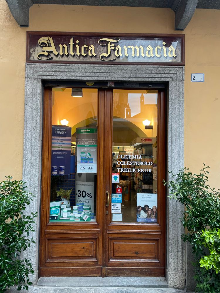 A glass painted sign above the pharmacy in Italy. The sign says ancient pharmacy.