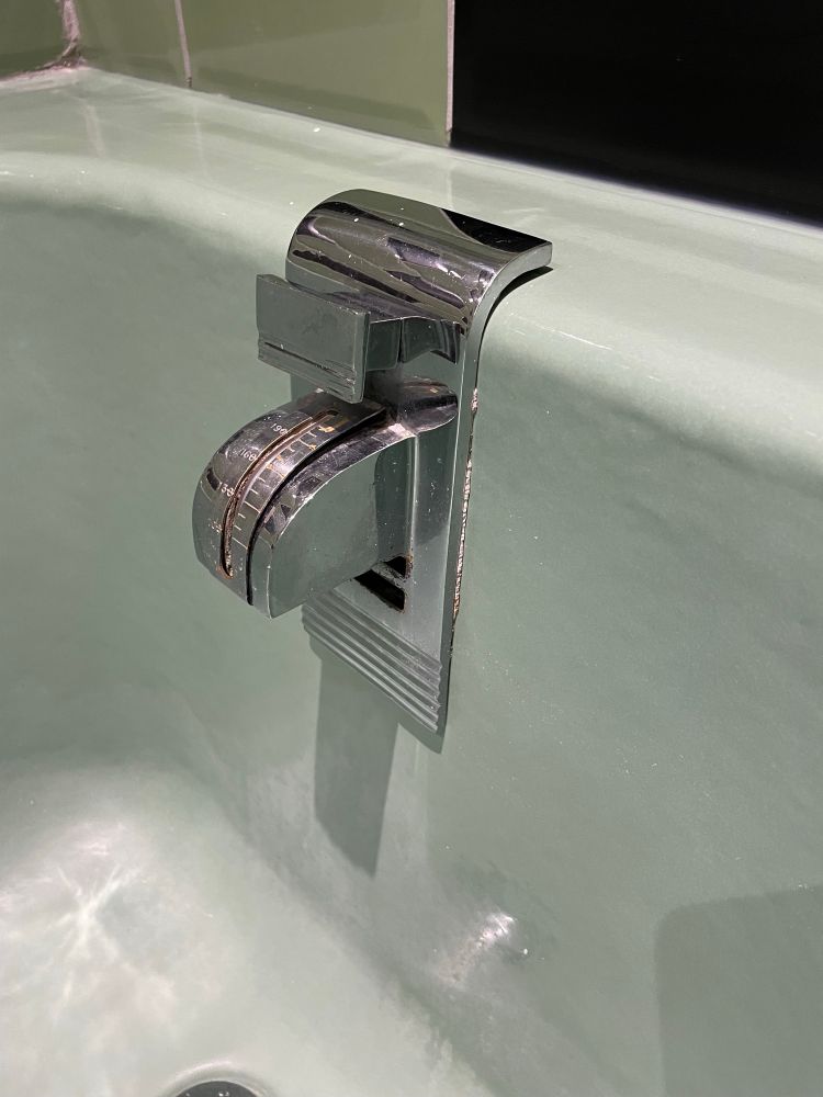A close-up of the water spout in the bathtub