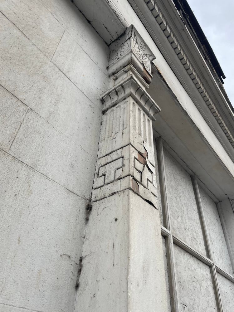 The top of a pilaster with peeling paint