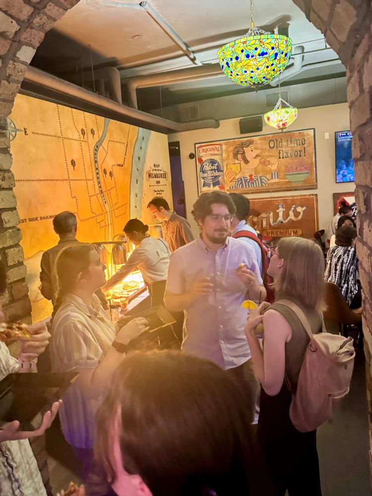Attendees at the event pictured talking and eating together.