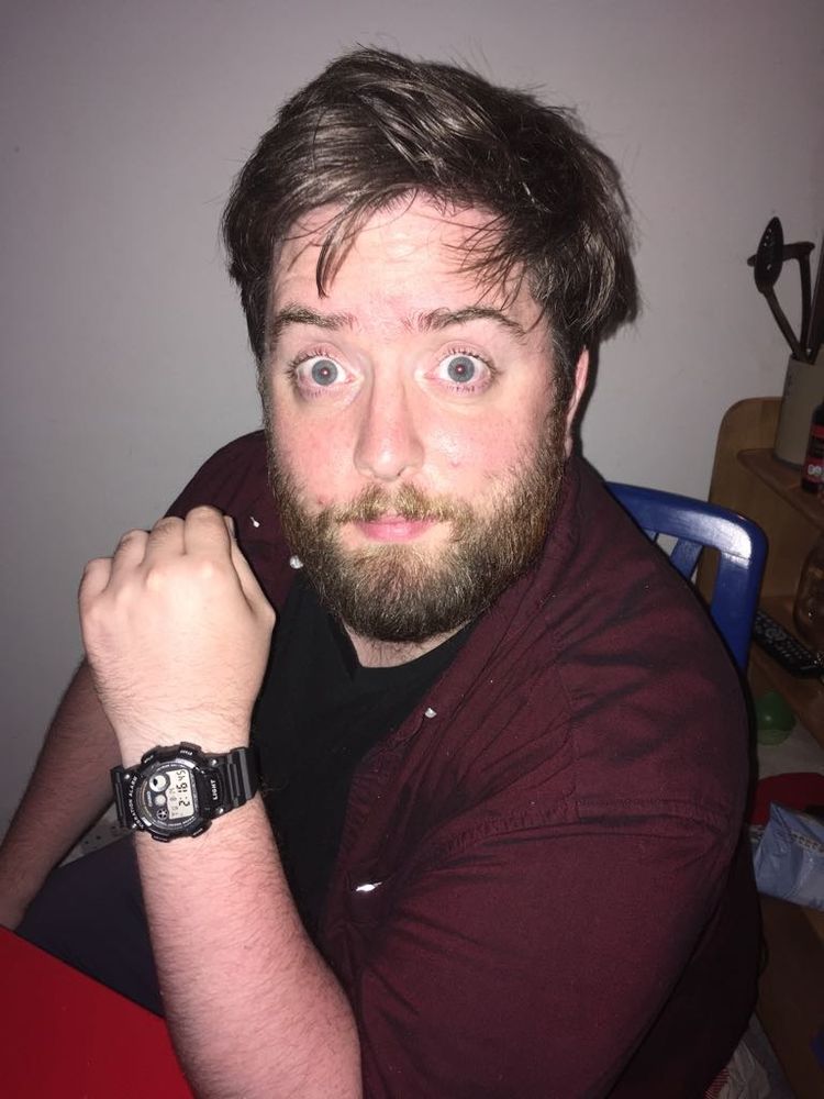 Photo of me from 2018 looking absolutely shook, like pure rough, my eyes are wide open, I'm caught with a look of shock on my face, I'm drunk, I'm at my heaviest, I'm wearing a wine coloured shirt, my hair is greasy and I have a beard, my friend takes the photo at a downwards angle, he's standing I'm sitting, it's 2:16 in the morning, it's the 14th of August, and I'm at the Airbnb of my (not great) old improv troupe, having split a bottle of whiskey with my mate after a bad show 