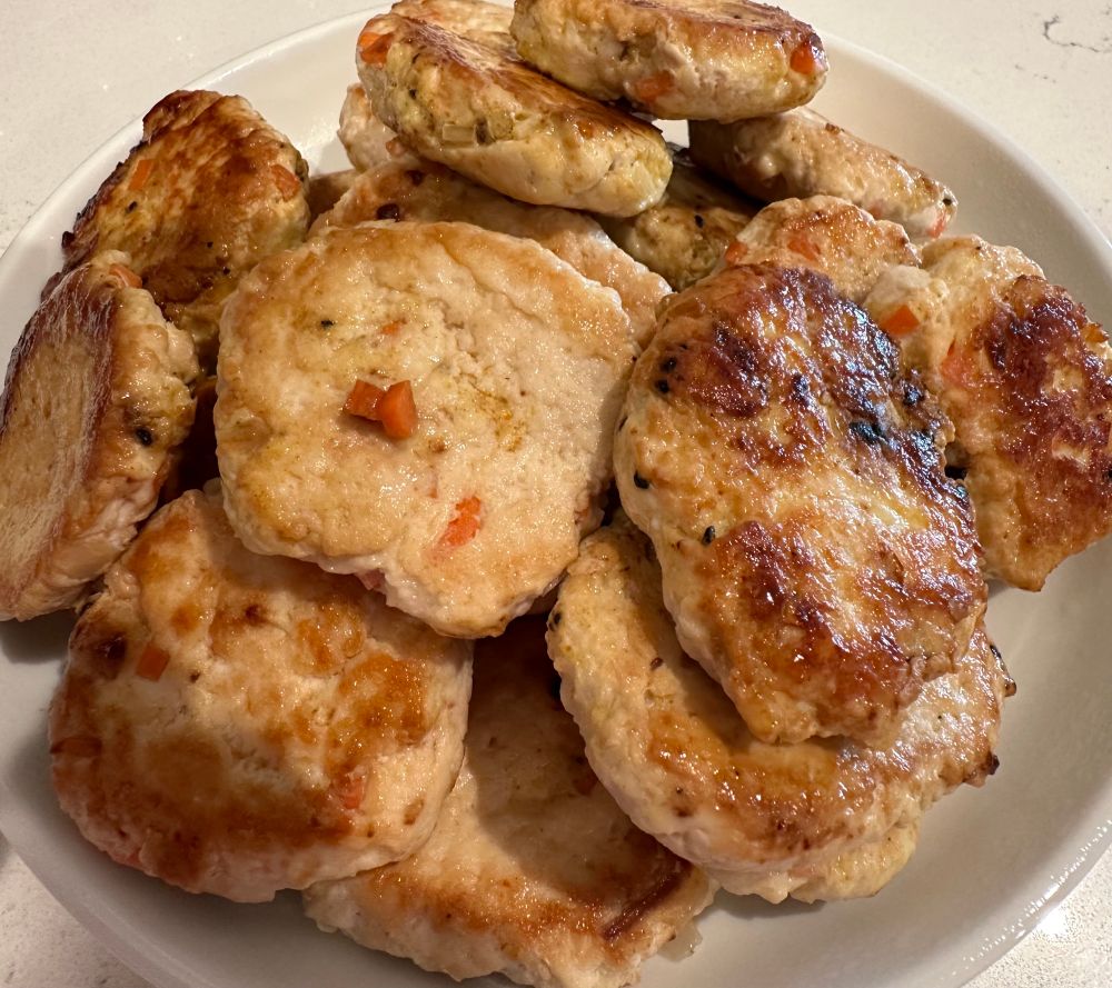 Slider size chicken burgers with diced carrots & shallots