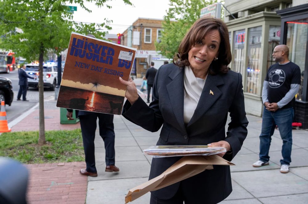 Kamala Harris holding up a vinyl copy of Minnesota's very own Hüsker Dü's album New Day Rising.