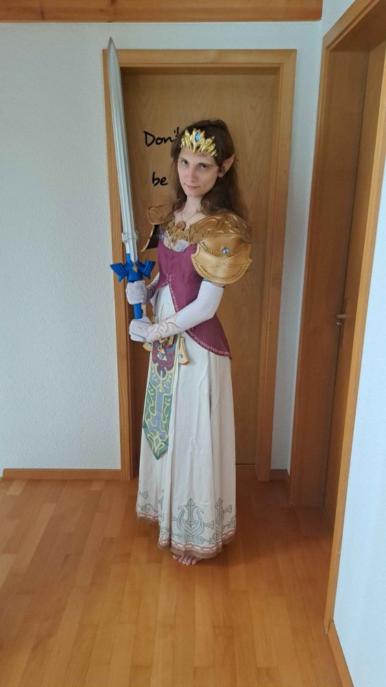 Me wearing a cosplay of Princess Zelda from "The Legend of Zelda: Twilight Princess" and holding a replica of the Master Sword.