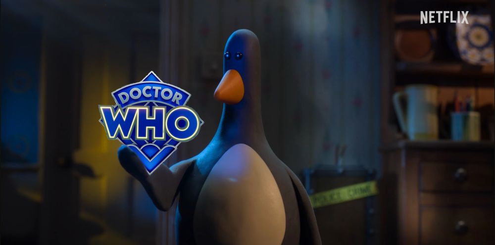 A still of Feathers McGraw holding the diamond Doctor Who logo