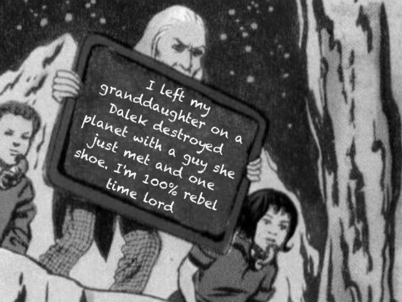 A still from a comic strip of the First Doctor holding a sign. The sign says “I left my granddaughter on a Dalek-destroyed planet with a guy she just met and one shoe. I'm 100% rebel time lord”
