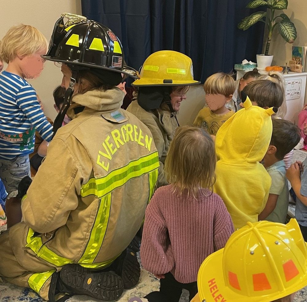 Firefighters teach children about fire safety at home.