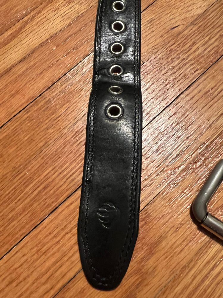 Black leather Wolverine belt with grommets for belt holes.  