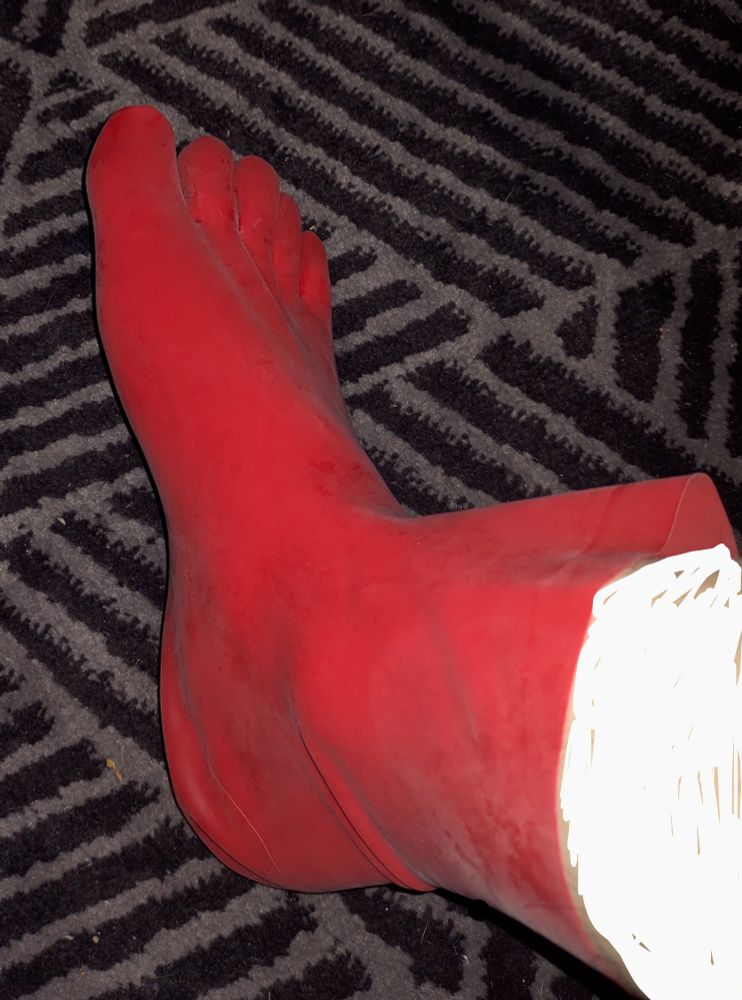 Red latex tea socks going up to just above the ankle. The fit around the heel and ankle area is a bit loose, but otherwise it is pretty skin tight.
The leg above the end of the sock is censored, because I am self conscious about not having shaved in a while :(