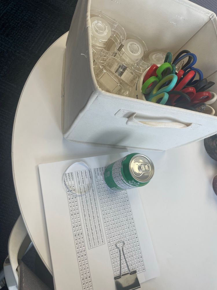 Tons of scotch tape, scissors, Enigma settings printed on paper and an example build of a soda can enigma machine using a Sprite can.
