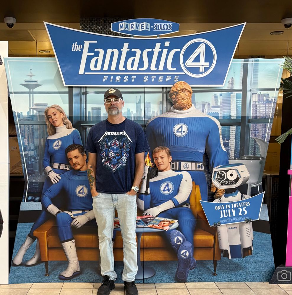 Me in front of a life size standee advertisement for “Fantastic Four: First Steps”.  