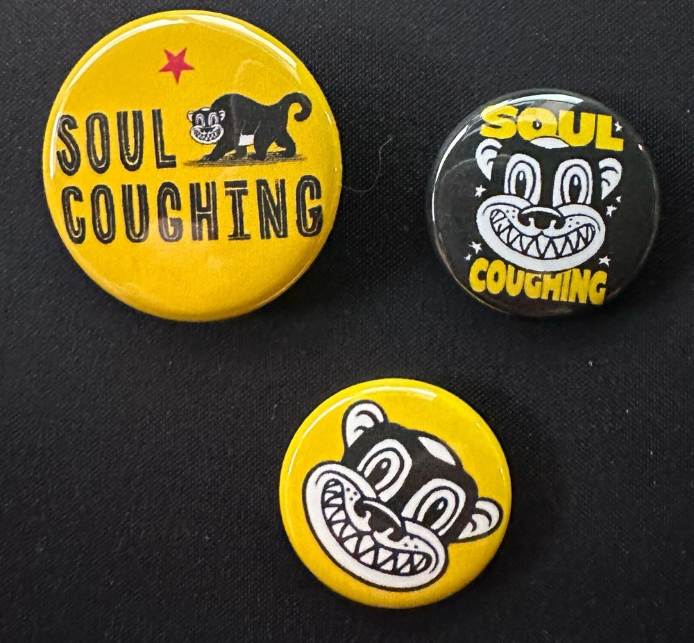 Three buttons, two 1” and one 1.25”. The larger is the soul coughing logo from their last album, with the other two being the monkey head on a yellow background and the monkey logo with the text soul coughing