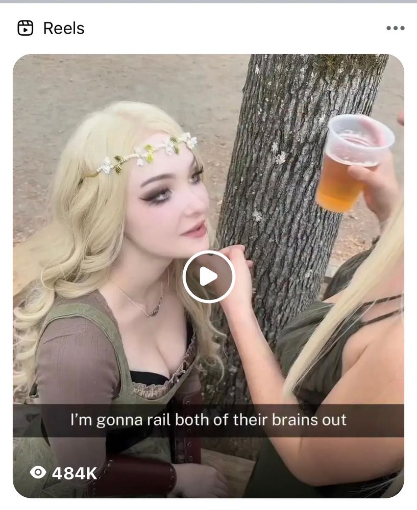 A Facebook suggested reel showing two women, one is kneeling before the other, and the other is holding a beer. But text on the video says “I’m gonna rail both of their brains out” 
