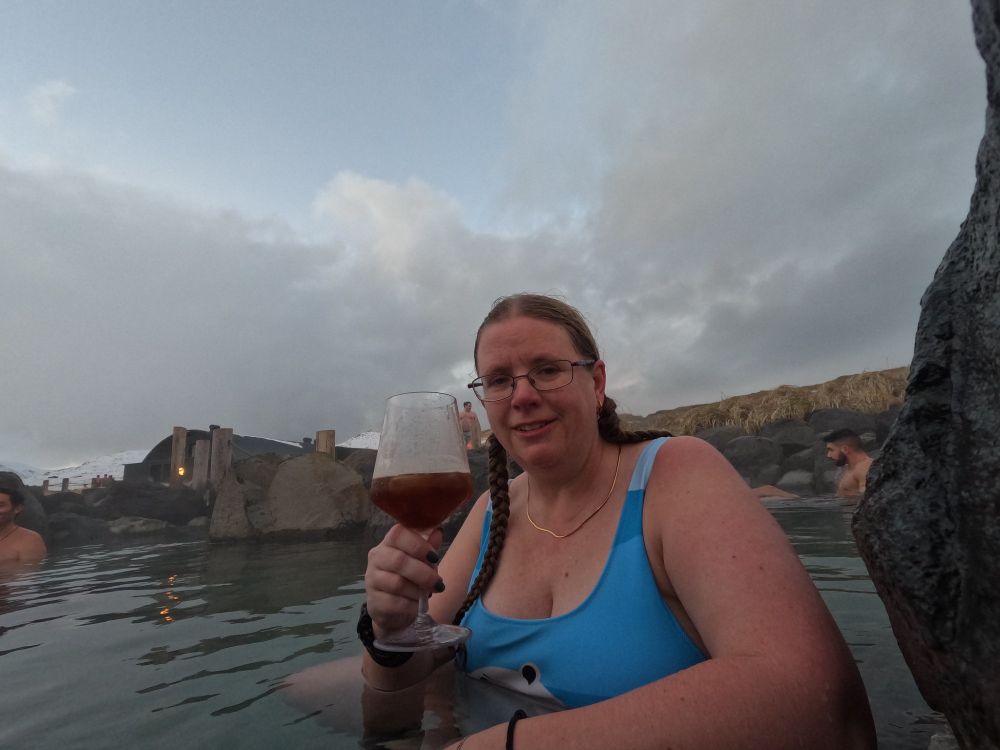 Me in pool 10 with a large plastic wine glass full of "Christmas drink" - malt & Egil's Appelsin, an Icelandic fizzy orange drink.