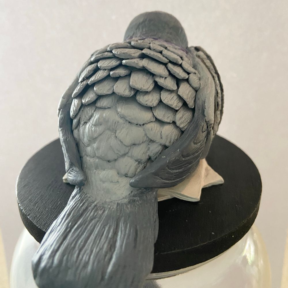 Back view of pigeon on jar