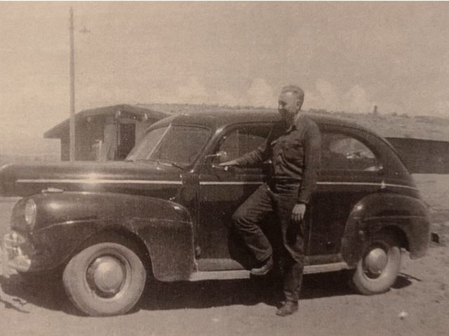 My dad next to his car