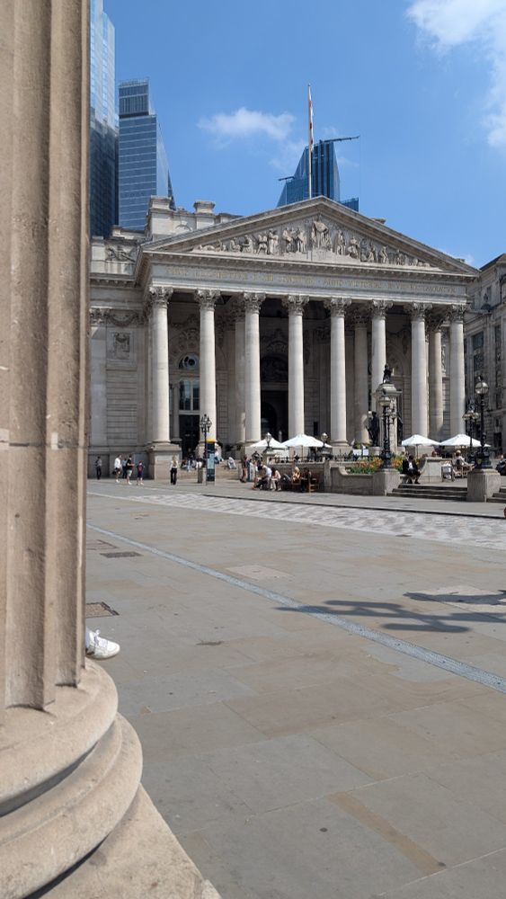 Picture of a classical building with columns on a sunny day. 