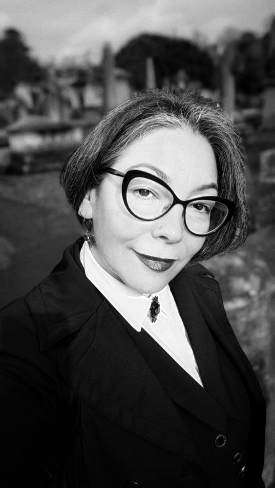 Image of woman with short hair wearing glasses at Brompton Cemetery. 