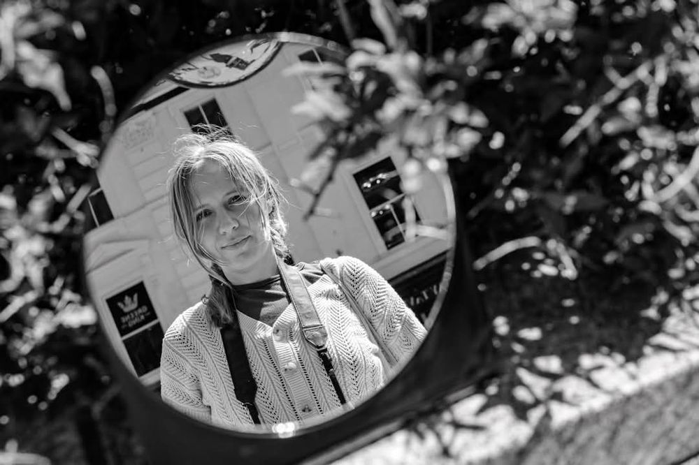 Mirror with reflection of a young woman. 