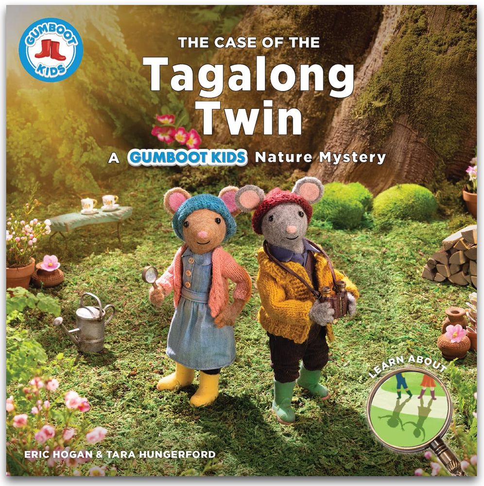 Book cover of The Case of the Tagalong Twin: A Gumboot Kids Nature Mystery by Eric Hogan and Tara Hungerford. It depicts two felted mice wearing gumboots in the forest. A magnifying glass titled Learn About shows shadows.