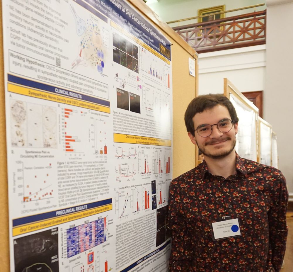 Graduate student Andre Martel Matos stands next to his poster entitled: Sympathetic Neurotransmission Contributes to Oral Cancer-Induced Spontaneous Pain.