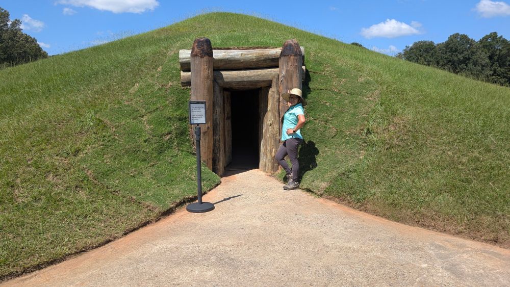 Faye Ross at the entrance of the Earth Lodge. 