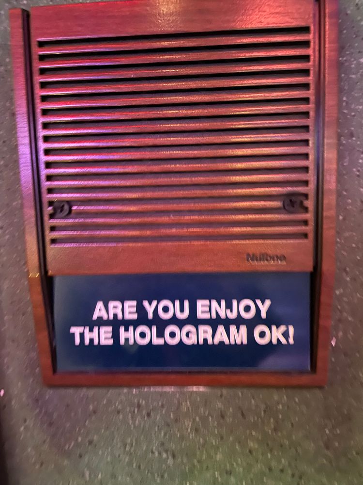 Building call box that reads, “Are you enjoy the hologram ok!”