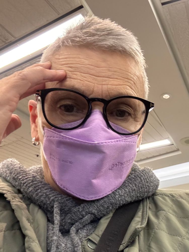 Woman wearing purple n95 mask 