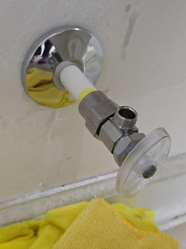 A newly installed supply line valve for a toilet. 
