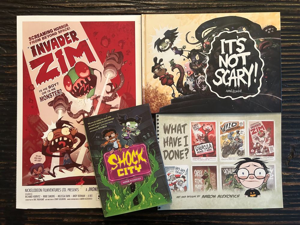 A collection of neat objects for sale: A b-movie styled Invader ZIM print, a SHOCK CITY graphic novel, my IT'S NOT SCARY! children's book, and an art book collecting a bunch of my creepy work.