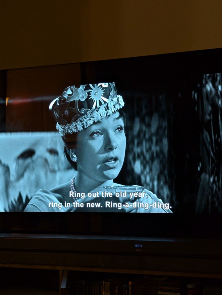 A television with an image of Shelly Winters wearing a crown in The Apartment and the caption "Ring out the old year. Ring in the new. ring a ding ding." 