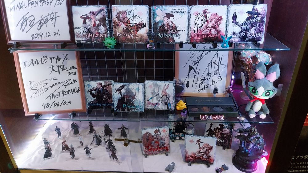 Assorted ff14 merch including some official signatures.