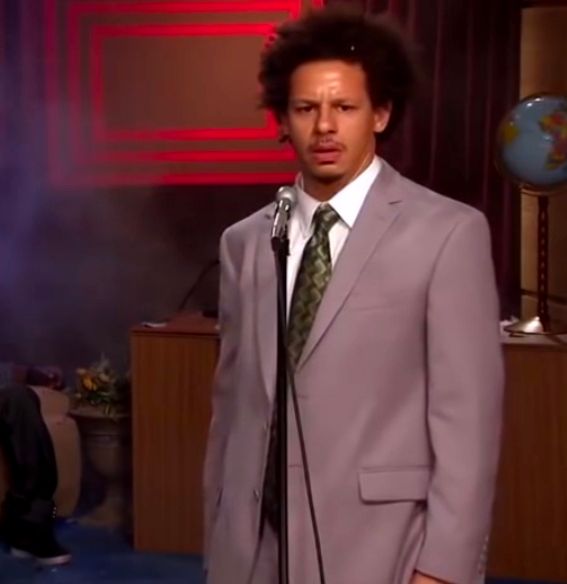 Cropped still from a The Eric Andre Show sketch, taking place shortly after Eric has unloaded multiple clips into his cohost, and now looks into the camera and wonders aloud "Who killed Hannibal Buress?"