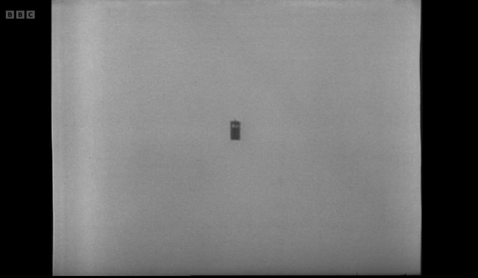 A screenshot from the eighth episode of the Doctor Who serial The War Games. An image of a clear sky. In the middle of the screen, the Tardis can be seen very far away in the distance.