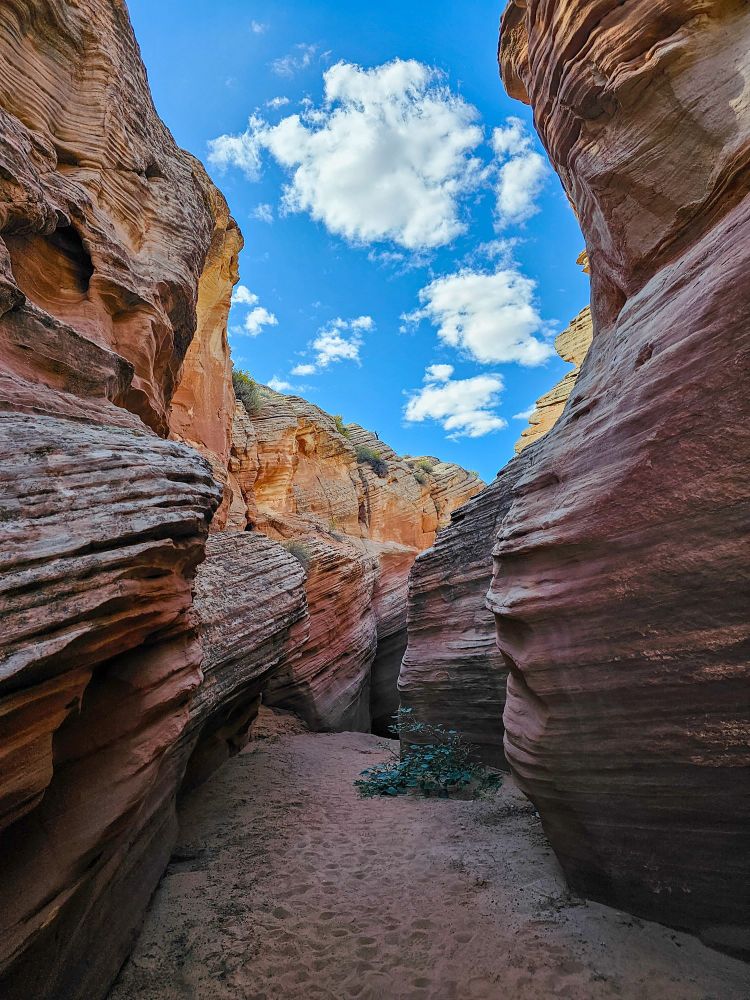 A beautiful blue sky above the terracotta coloring of the textured walls of a slot Canyon in Utah! 