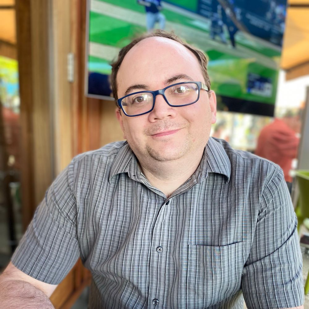 A photo of birthday boy James at a pub with the Blue Jays playing in the background. 