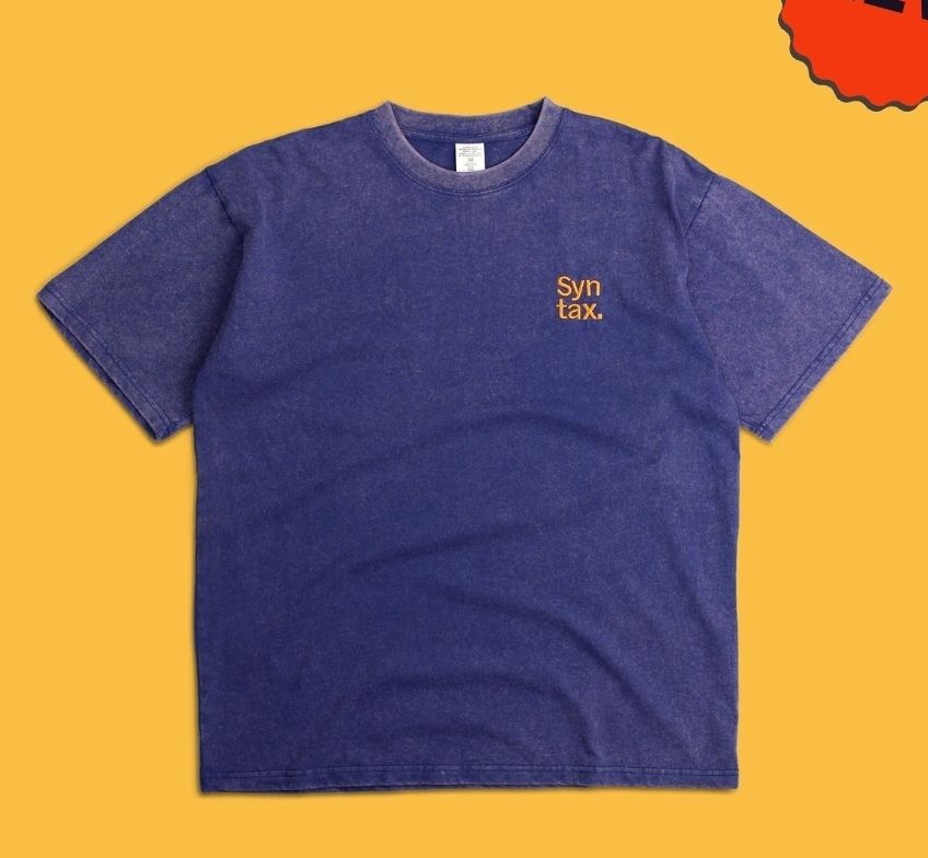 Mineral washed big purple t-shirt with "syntax." written on it.