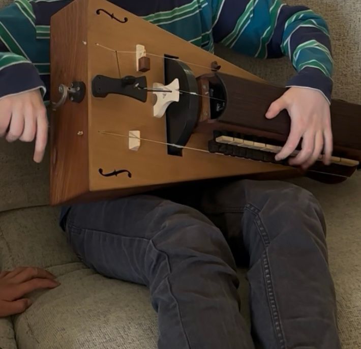 Kid playing the hurdy gurdy