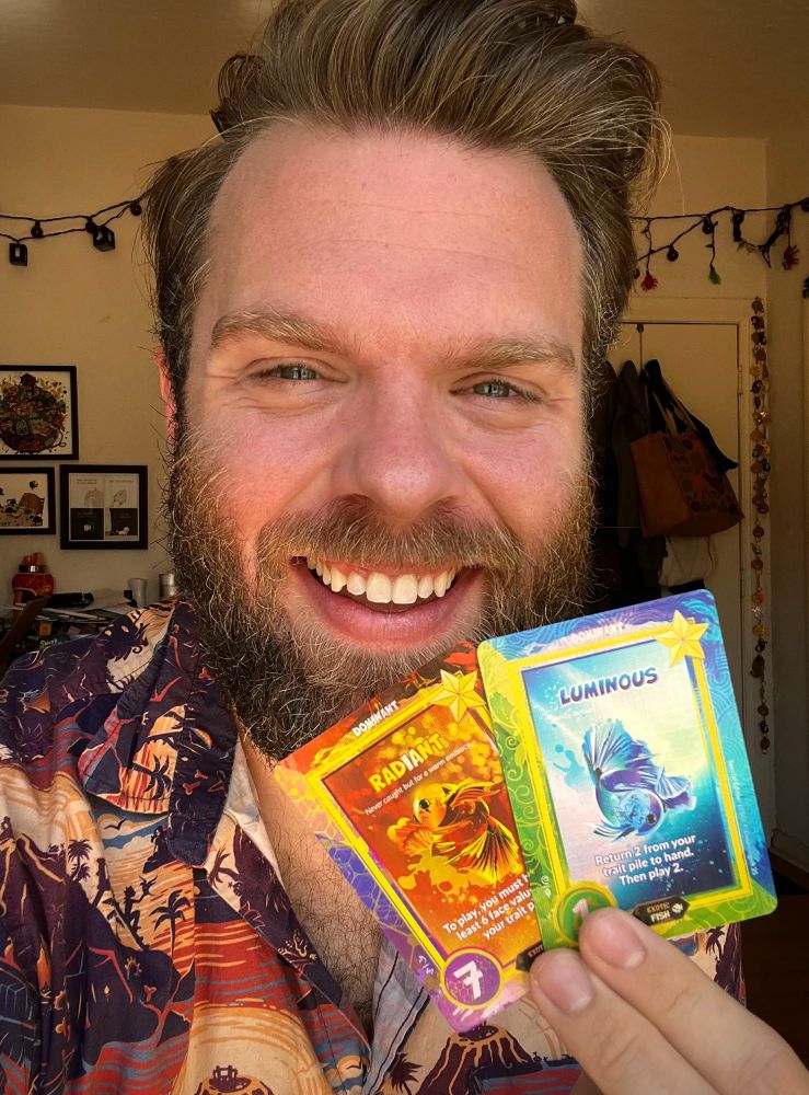 Robo Holding the two limited holofoil cards smiling