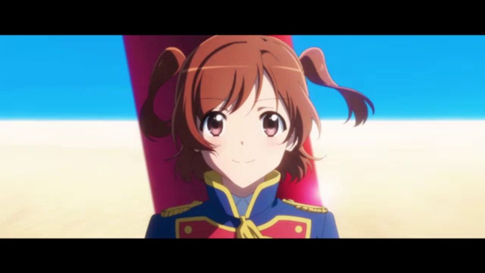 a girl in a blue and red uniform is smiling in front of a blue sky