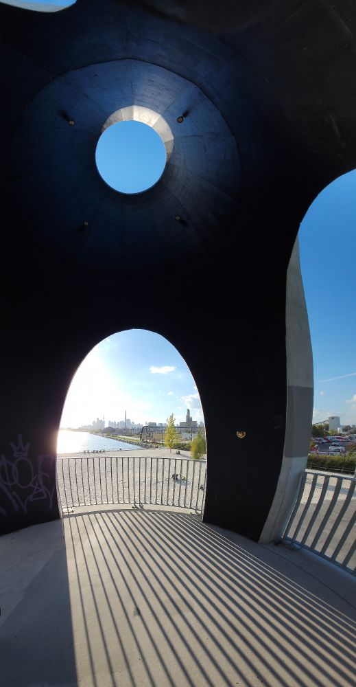 A vista of water and sky as viewed through oddly-shaped windows.
