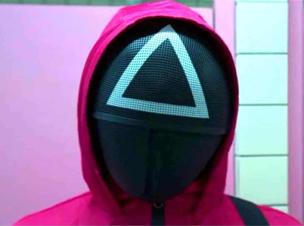 A squid game sniper in a pink jumpsuit and a black mask featuring a triangle 
