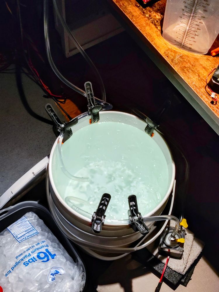 a 5gal bucket of icewater with a pump apparatus, and a large plastic bag of ice