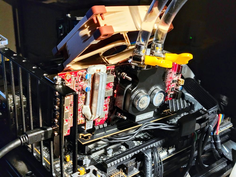 a Radeon HD7750 graphics card mounted on a riser and featuring liquid cooling