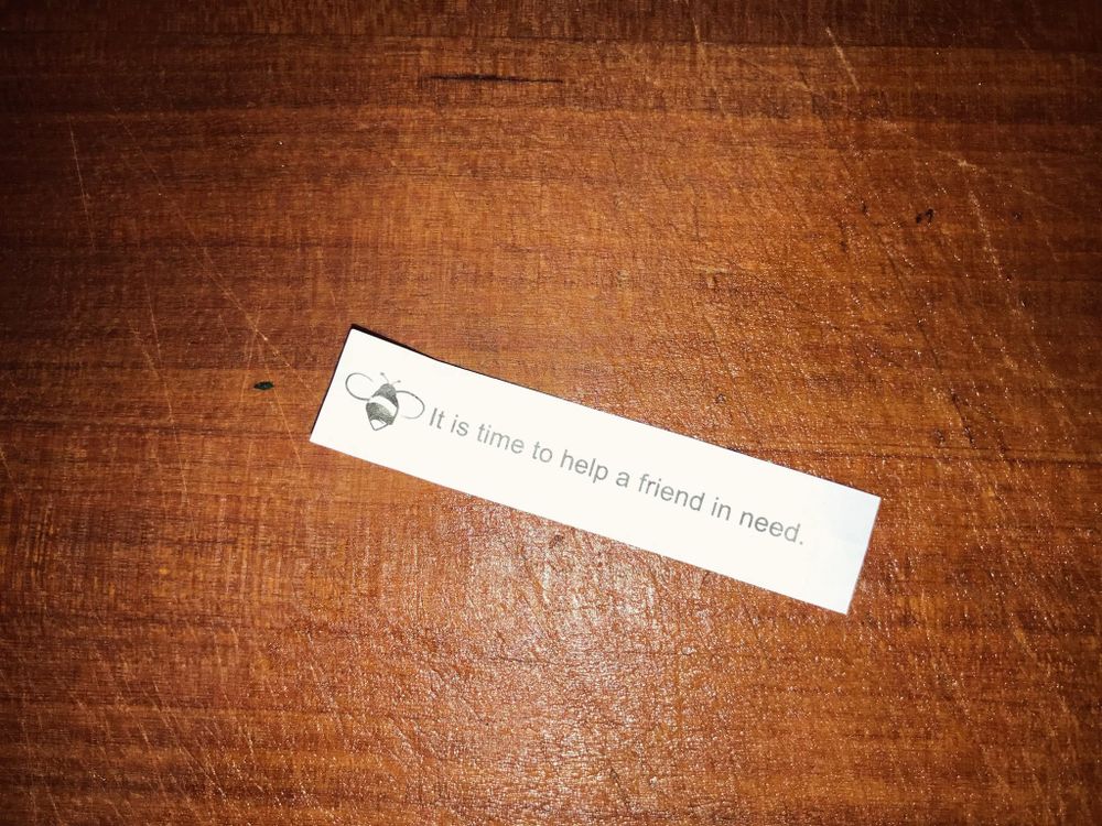 Fortune cookie fortune that reads “it’s time to help a friend in need”.