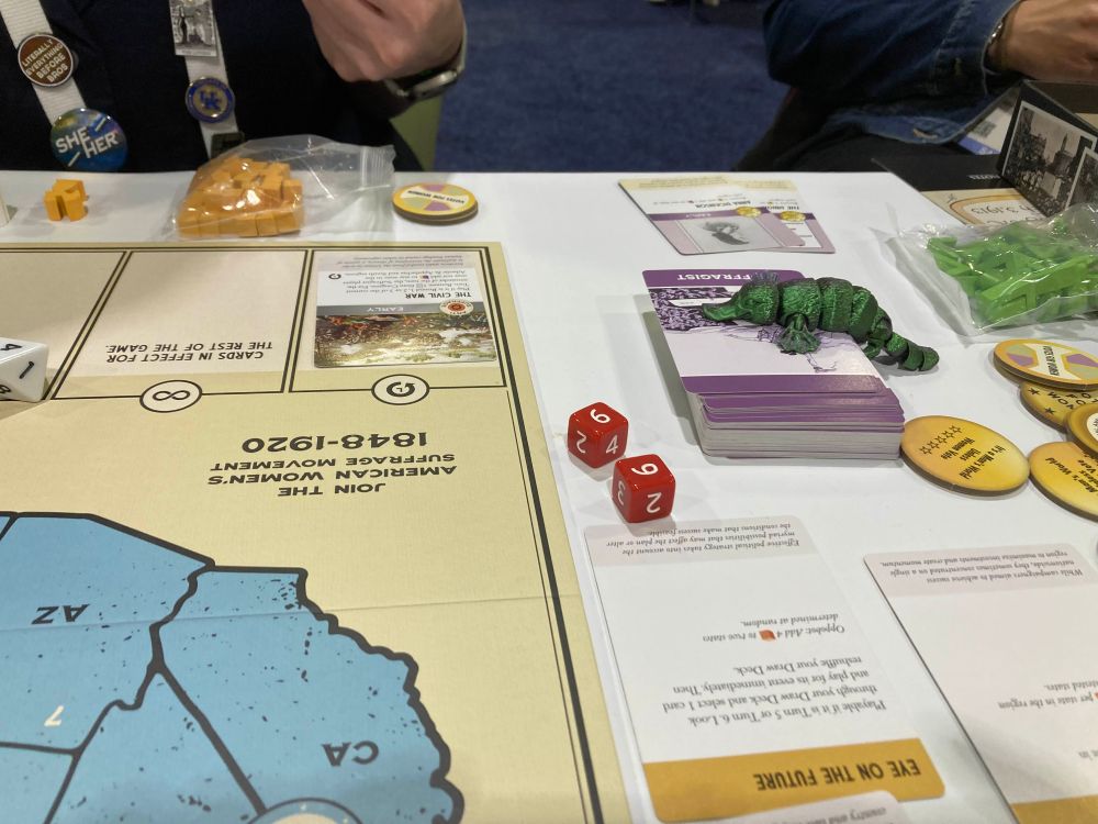 Small 3d printed Platypus on the board game components of Votes for Women