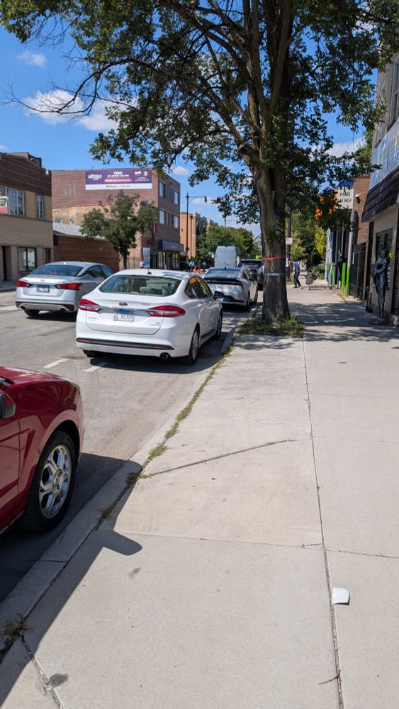 At least 5 cars parked in the bike lane northbound on Milwaukee north of Pulaski