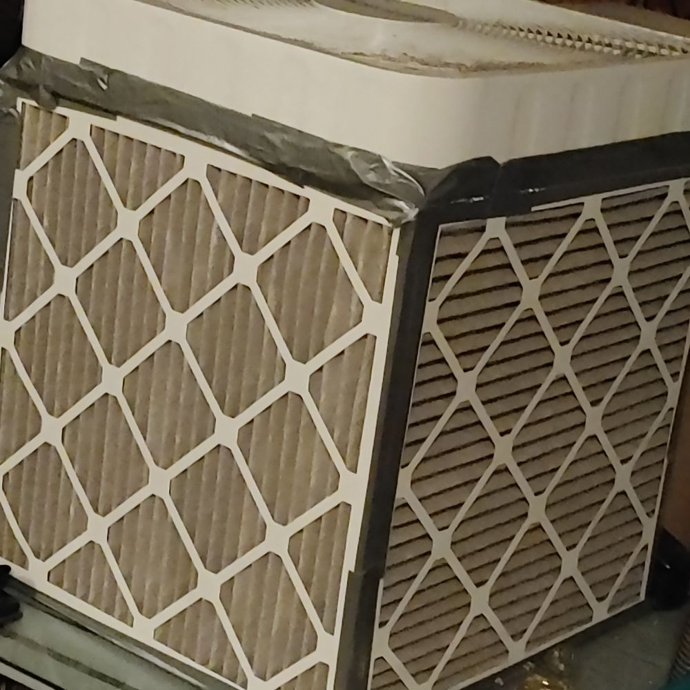 A Corsi-Rosenthal box with grey filters that need to be changed 