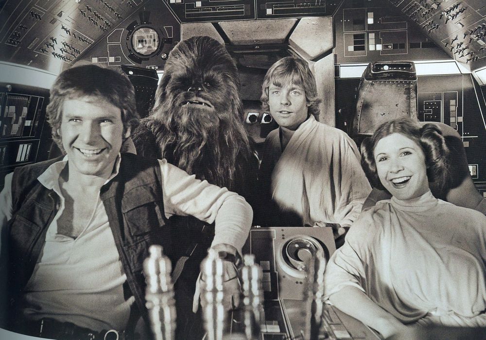 Star Wars: Han, Chewie, Luke, and Leia laughing in the cockpit of the Falcon