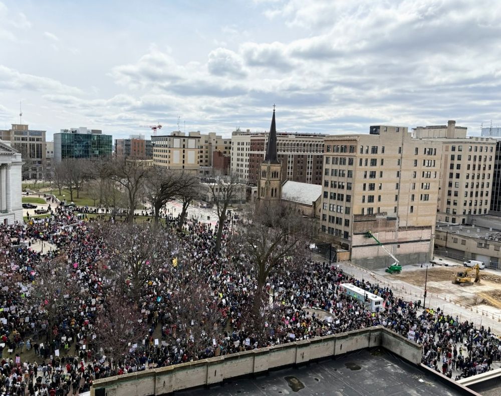Hundreds of perhaps thousands of protestors on the Square in Madison Wisconsin under partly cloudy skies taken from above